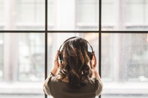 Back of woman's head listening to headphones