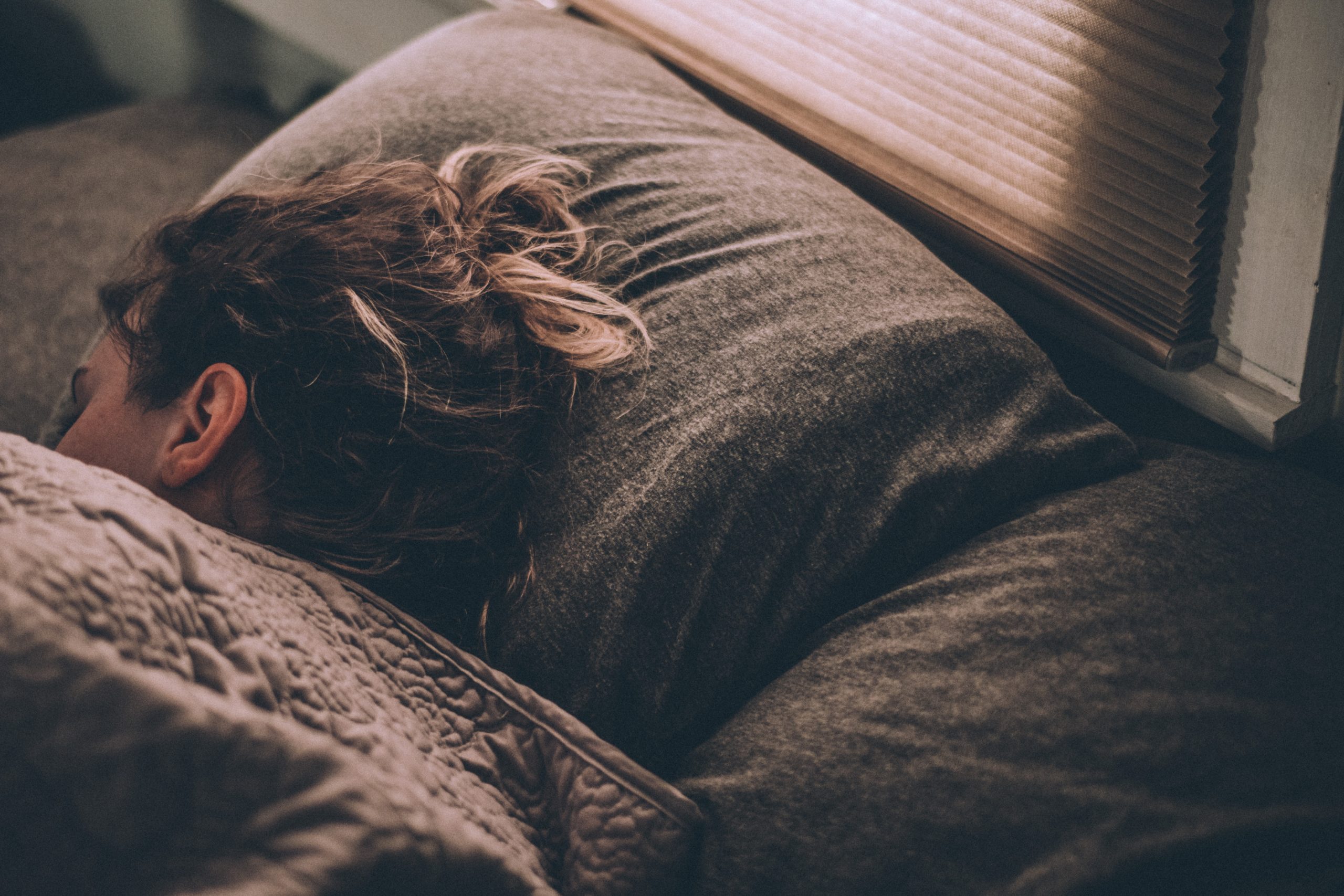 Woman sleeping on grey pillow